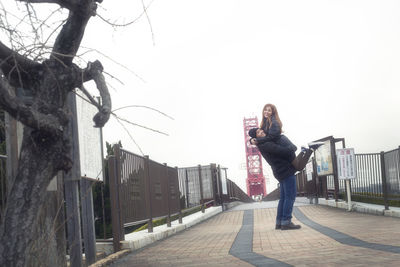 Woman standing against clear sky