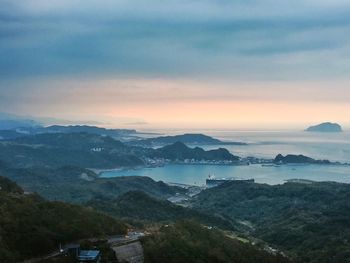 Scenic view of sea and mountains against sky