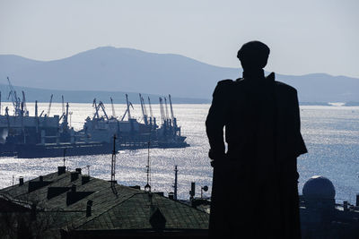 View of silhouette statue against sea