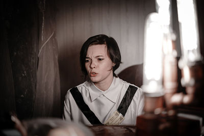 Young woman sitting at restaurant table