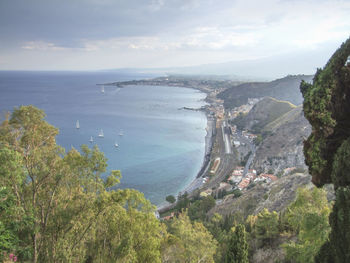 High angle view of trees and sea against sky