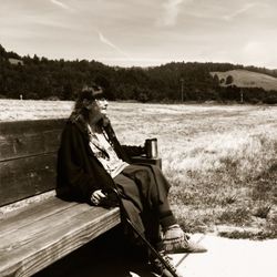 People relaxing on grassy field