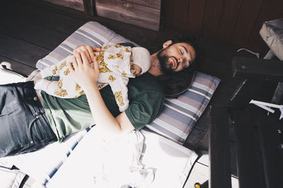 High angle view of man sitting on seat