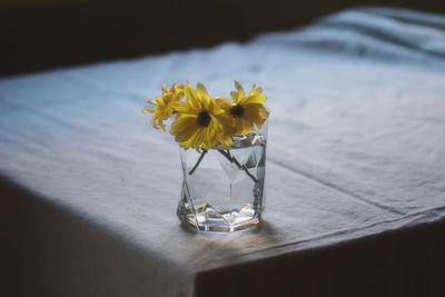Close-up of yellow flower in vase on table
