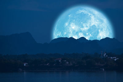Scenic view of silhouette mountains against sky at night