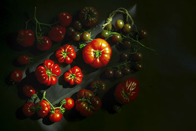 Kitchen still life, top view - tomatoes of different sizes, varieties and shades.