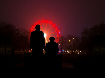 Rear view of man standing against sky during sunset