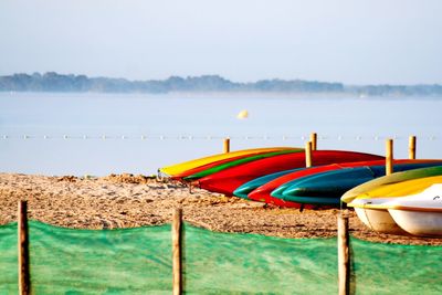 Boat moored on beach against sky