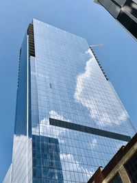 Low angle view of modern building against clear blue sky