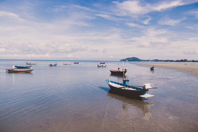 Boats in sea against sky