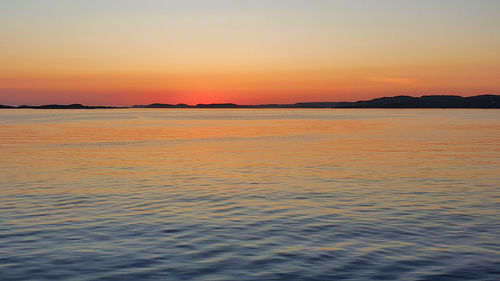 Scenic view of sea against romantic sky at sunset