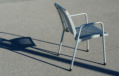 High angle view of empty chair on road