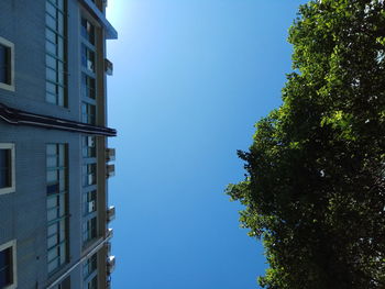 Low angle view of building against clear blue sky