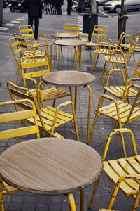 Empty tables and chairs at sidewalk cafe