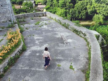 Rear view of woman walking on staircase