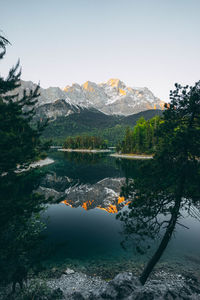 Scenic view of lake by mountains against sky