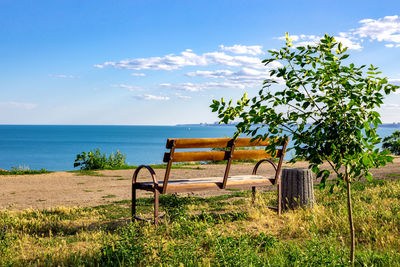 Old wooden bench to rest on access to the beach, sunset at a beach of baltic sea on summer evening