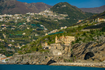 Scenic view of sea and mountains against sky