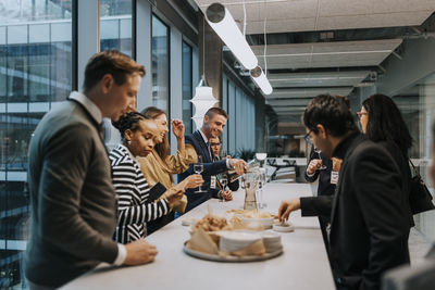 Multiracial business people with food and drink during seminar