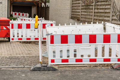 Row of red fence on street in city