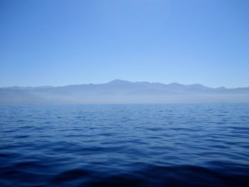 Scenic view of sea against clear blue sky
