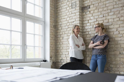 Mature businesswoman working with younger colleague in office