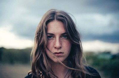 Portrait of a serious young woman outdoors