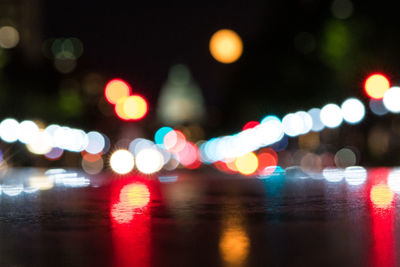 Defocused image of illuminated city street at night