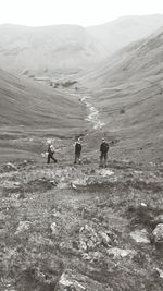 People on landscape against sky