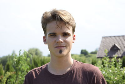 Portrait of young man against sky