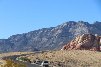 Scenic view of mountains against clear blue sky