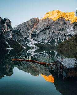 Scenic view of lake and snowcapped mountains against sky