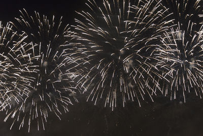 Low angle view of firework display at night