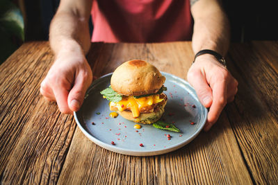 Midsection of man having food in plate