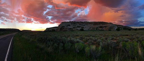 Scenic view of field against sky at sunset