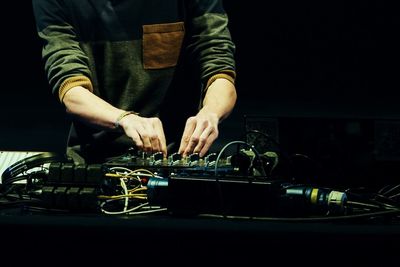 Man mixing music in sound mixer