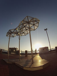 Traditional windmill against sky during sunset