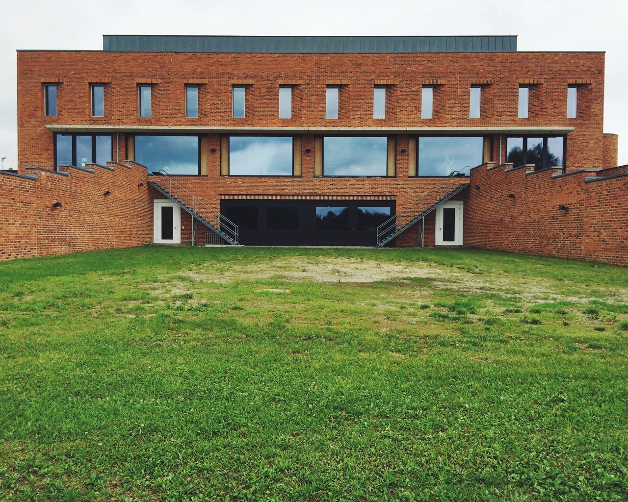 architecture, grass, built structure, building exterior, lawn, grassy, field, green color, history, building, day, sky, outdoors, no people, clear sky, old, window, plant, sunlight, the past