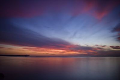 Scenic view of sea against romantic sky at sunset