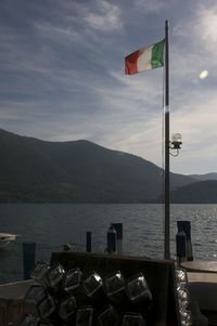 Scenic view of sea and mountains against sky