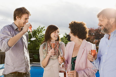 Happy people drinking champagne together