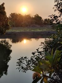 Scenic view of lake against sky during sunset