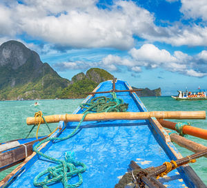 Fishing boat on sea against sky