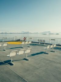 Empty seats in airport against clear sky