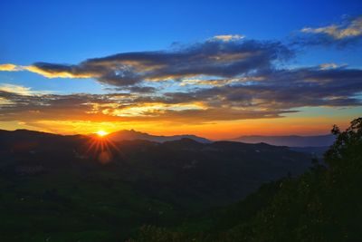Scenic view of silhouette mountains against sky at sunset