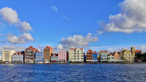 Buildings in city against blue sky