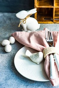 Festive table setting for holiday easter dinner in pale pink color