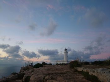 Lighthouse against cloudy sky