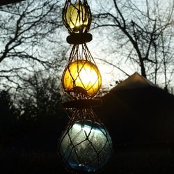 Low angle view of electric lamp hanging on ceiling