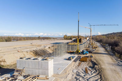 Construction site by road against sky